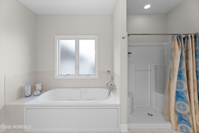 full bathroom featuring a garden tub and a shower stall