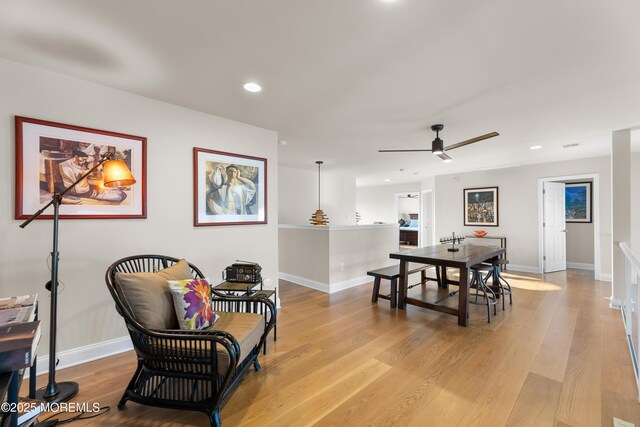 dining area featuring baseboards, ceiling fan, light wood-style flooring, and recessed lighting