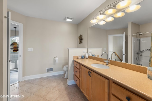 bathroom with a shower, visible vents, toilet, vanity, and tile patterned flooring