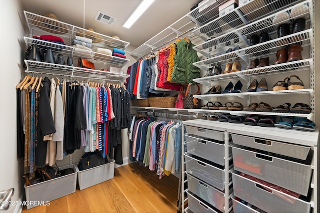 spacious closet featuring visible vents and wood finished floors