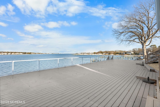 wooden terrace featuring a water view