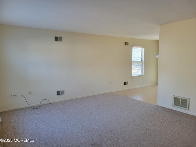 empty room with light colored carpet and visible vents