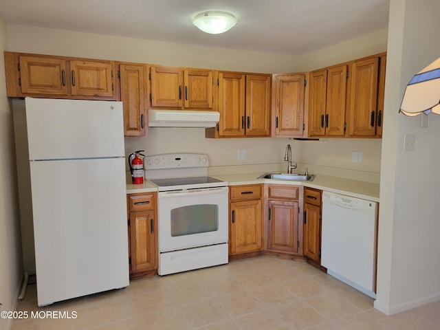 kitchen with white appliances, light countertops, a sink, and ventilation hood