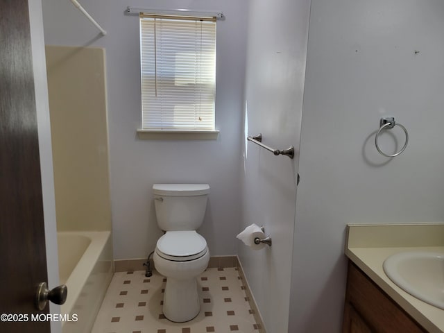 full bath featuring baseboards, vanity, and toilet