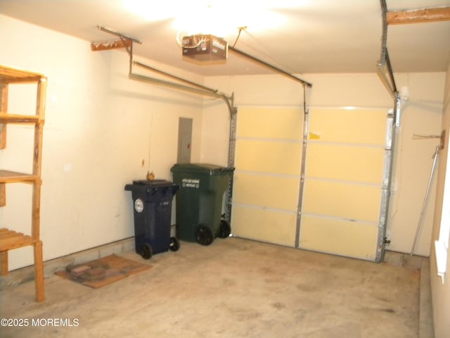 garage featuring electric panel and a garage door opener