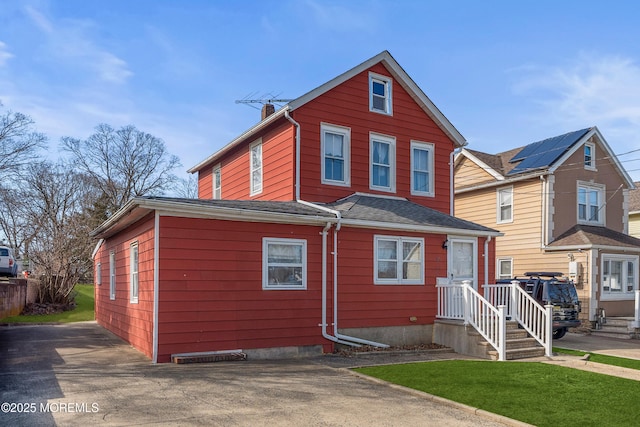 view of front of property with roof with shingles