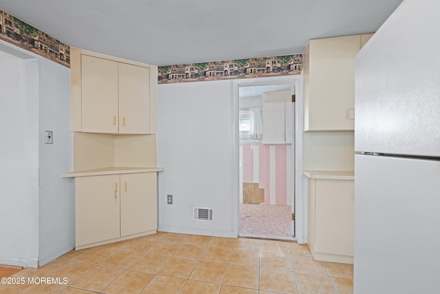 unfurnished dining area featuring visible vents and light tile patterned floors