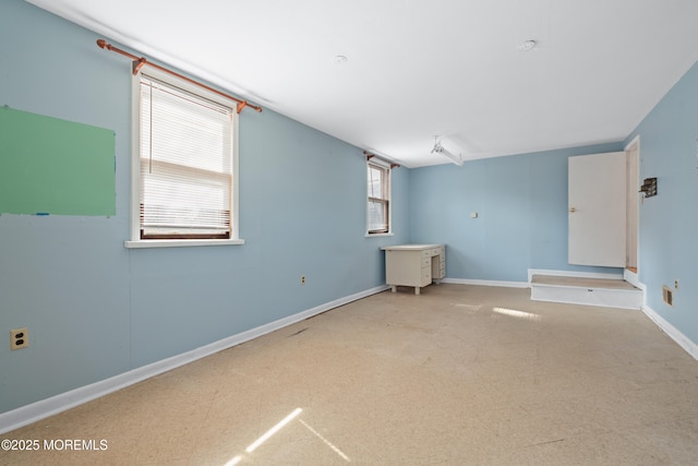 unfurnished room featuring baseboards