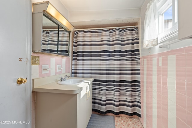 bathroom featuring a shower with curtain, tile walls, and vanity