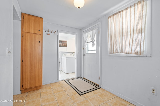 entrance foyer with washing machine and dryer and light tile patterned flooring