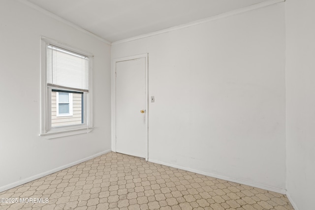 unfurnished room featuring light floors, ornamental molding, and baseboards