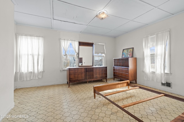 bedroom featuring baseboards, multiple windows, and visible vents