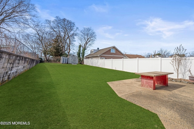 view of yard with a shed, a patio, a fenced backyard, and an outdoor structure