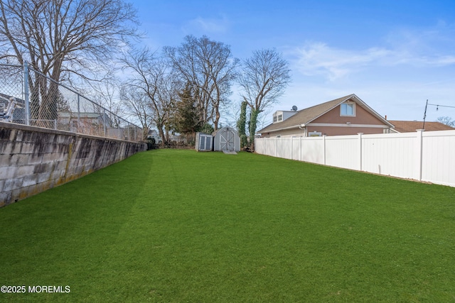 view of yard featuring a fenced backyard, an outdoor structure, and a shed