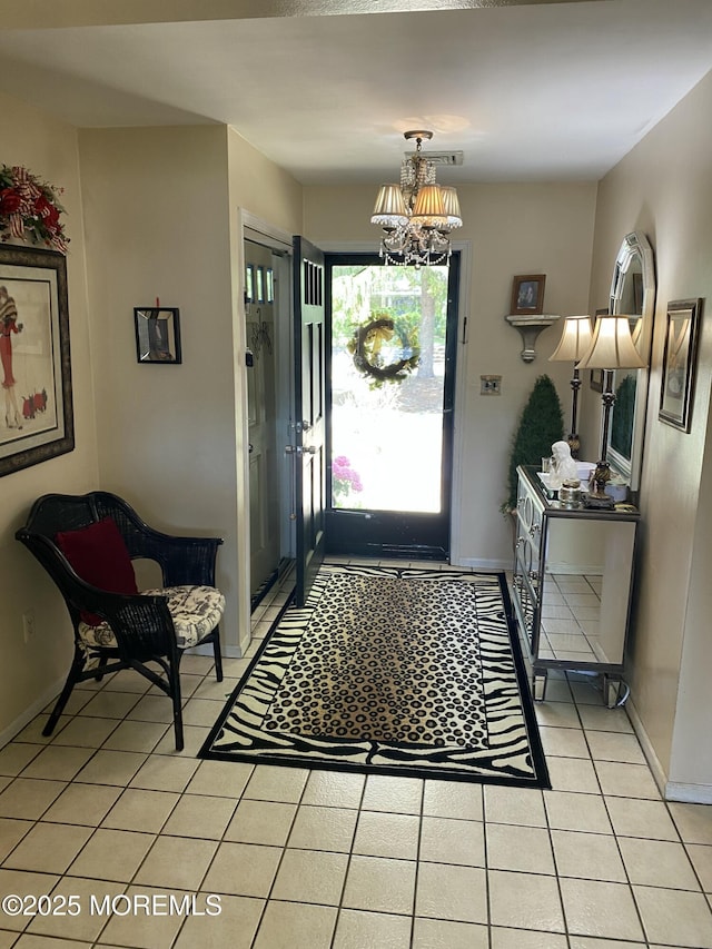 550 Wall St, Eatontown, NJ 07724 - foyer entrance with light tile patterned floors, baseboards, and a chandelier