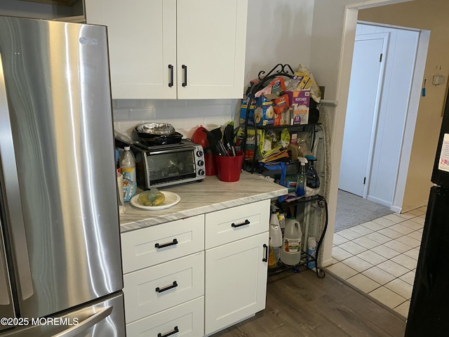 550 Wall St, Eatontown, NJ 07724 - kitchen with freestanding refrigerator, light countertops, and white cabinets