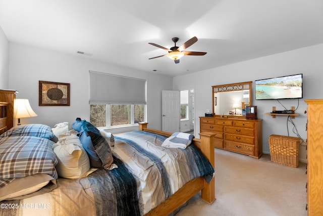 bedroom with light carpet, ceiling fan, and visible vents