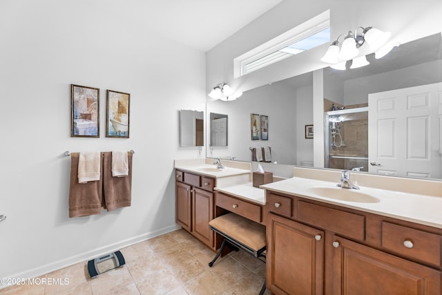 full bathroom with a stall shower, a sink, baseboards, and double vanity