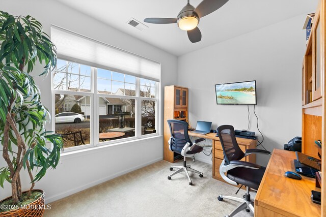 office area with carpet floors, baseboards, visible vents, and a ceiling fan