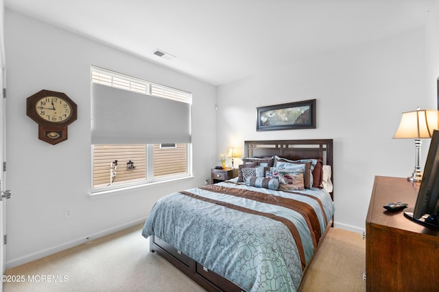 carpeted bedroom featuring visible vents and baseboards