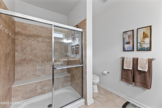 full bathroom featuring baseboards, a shower stall, toilet, and tile patterned floors