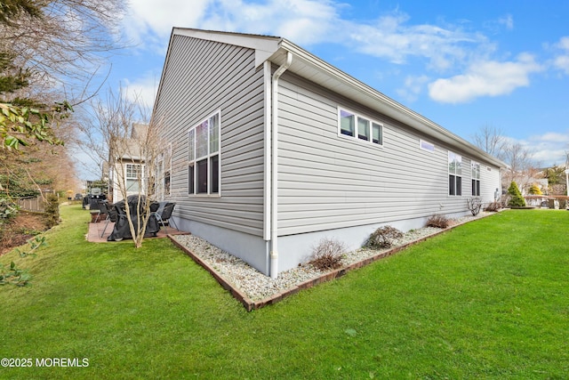 view of side of property featuring a yard