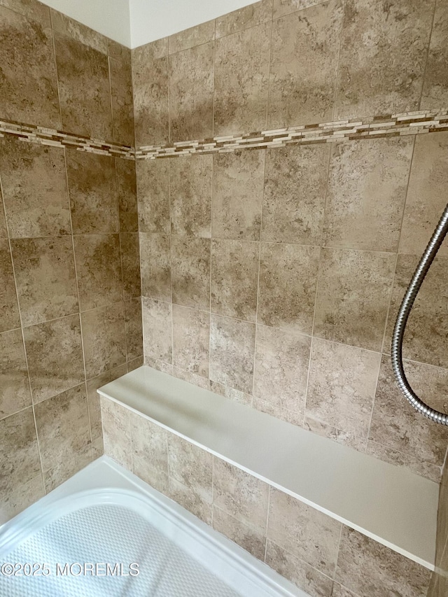 bathroom featuring a bathtub and a shower