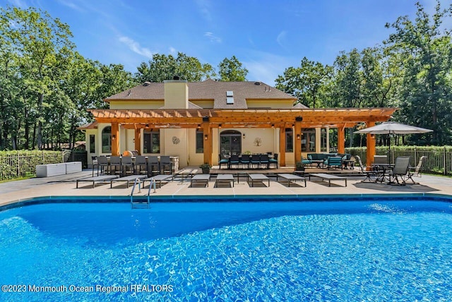 community pool featuring fence, outdoor lounge area, a pergola, and a patio