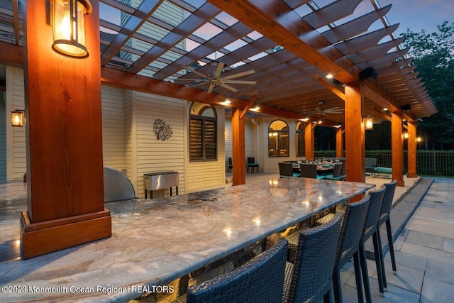 view of patio / terrace featuring outdoor dry bar, ceiling fan, and a pergola