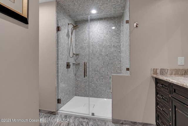 full bathroom featuring a stall shower and vanity