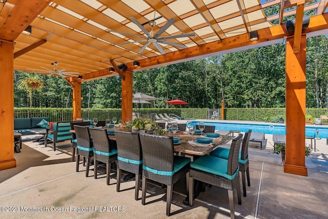 view of patio / terrace featuring outdoor lounge area, fence, a fenced in pool, and a pergola