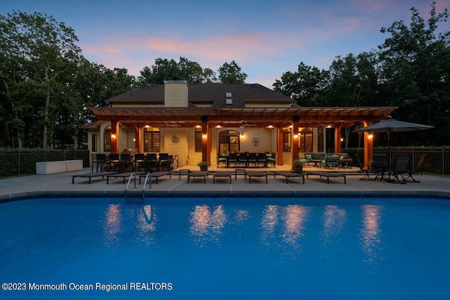 view of swimming pool featuring a fenced in pool, a patio, an outdoor hangout area, fence, and a pergola