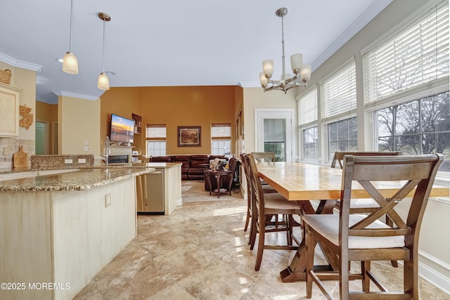 dining room with a notable chandelier and crown molding