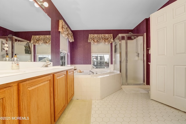 bathroom with double vanity, a sink, a shower stall, tile patterned flooring, and a bath