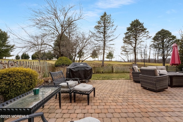 view of patio / terrace featuring a grill and fence