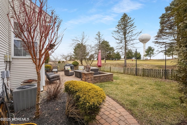 view of yard featuring outdoor lounge area, central AC unit, a patio area, and fence