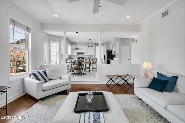 living room featuring dark wood-style floors, baseboards, crown molding, and recessed lighting