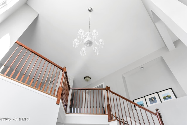 staircase with a chandelier