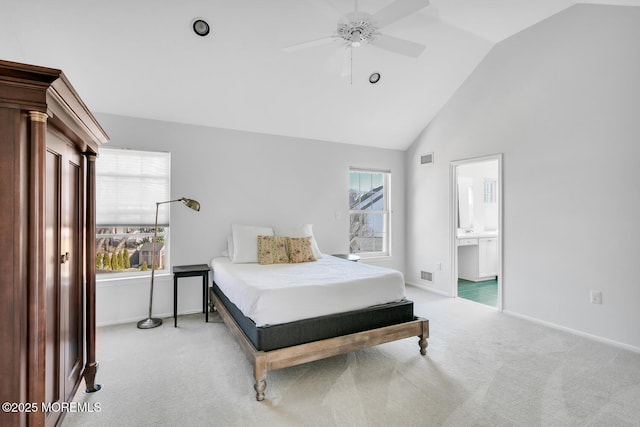 carpeted bedroom with lofted ceiling, visible vents, ensuite bathroom, a ceiling fan, and baseboards