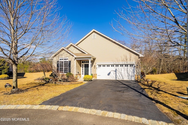 view of front of property featuring a garage, a front lawn, and aphalt driveway