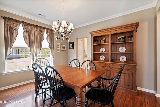 dining space featuring visible vents, baseboards, dark wood finished floors, crown molding, and a notable chandelier