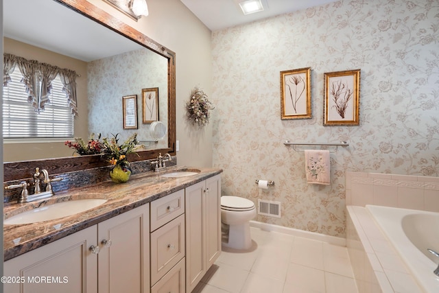 bathroom with toilet, a sink, visible vents, and wallpapered walls