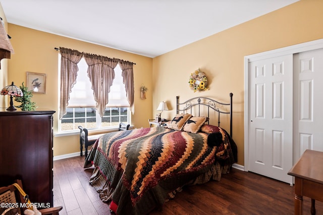 bedroom with dark wood-style flooring and baseboards