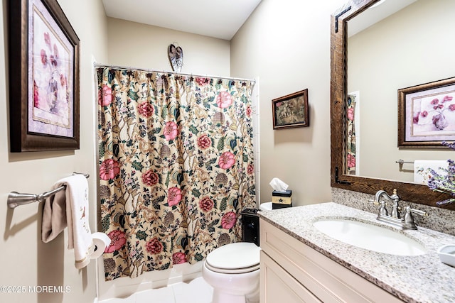 bathroom with a shower with shower curtain, vanity, toilet, and tile patterned floors