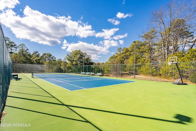 view of tennis court with fence