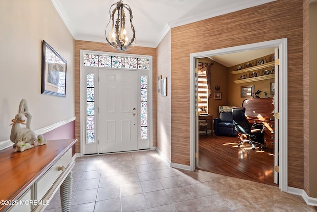 tiled entryway with ornamental molding, plenty of natural light, and baseboards