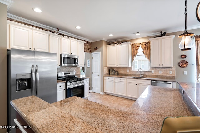 kitchen featuring appliances with stainless steel finishes, decorative backsplash, a sink, and ornamental molding