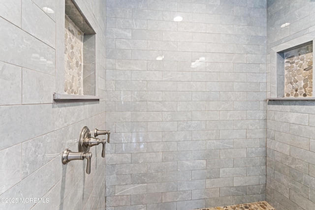 bathroom with a tile shower