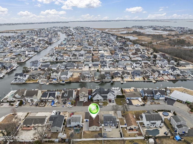 birds eye view of property with a water view and a residential view