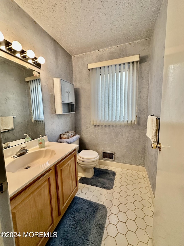 bathroom featuring visible vents, toilet, tile patterned flooring, a textured ceiling, and vanity